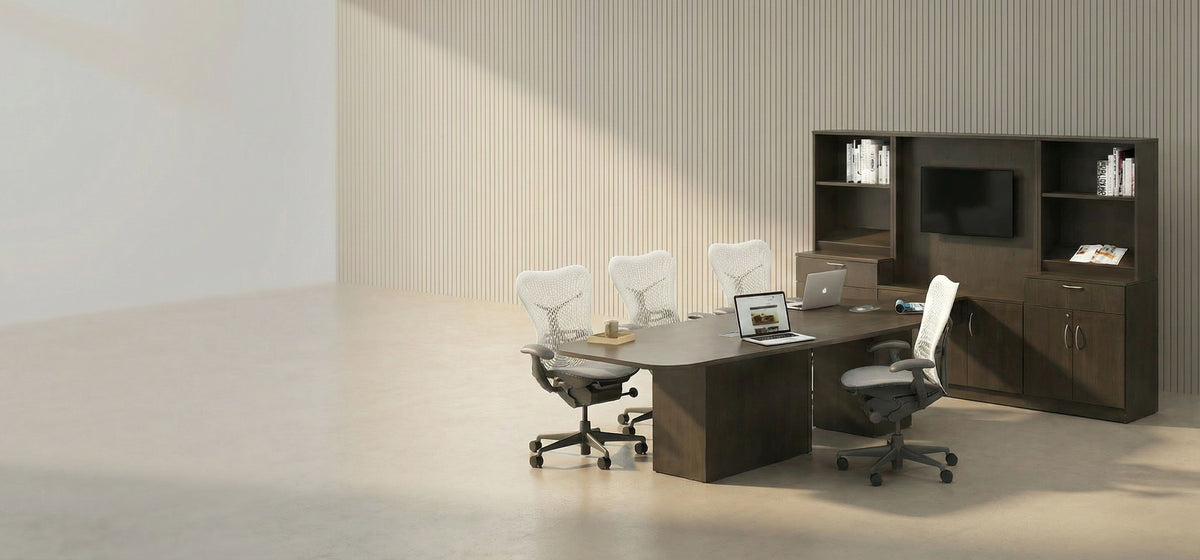 Modern office setup with a desk, chairs, and bookshelves in a neutral-colored room.
