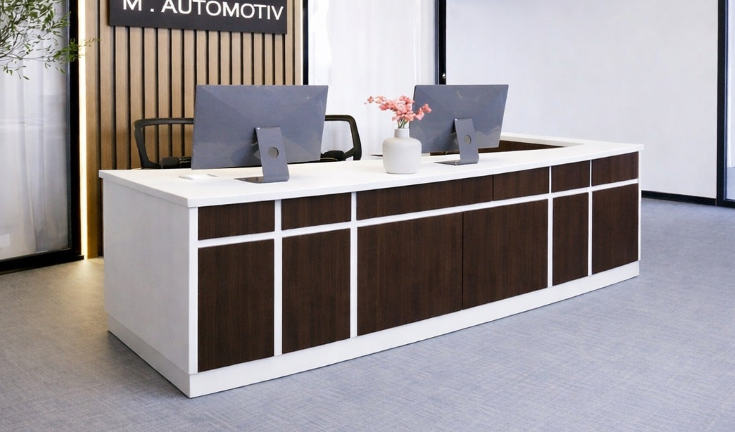 Modern office reception desk with computer monitors in a professional setting