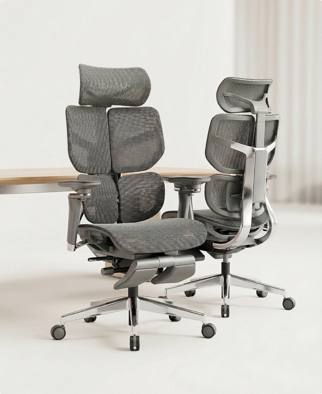 Two gray office chairs with headrests on a white floor.